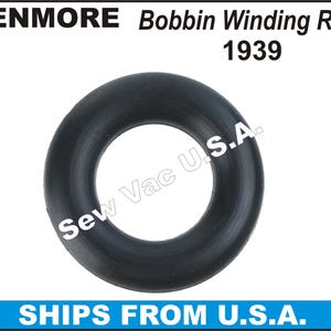 May include: Black rubber bobbin winding ring for a sewing machine. The ring is a simple circle with a hole in the center. The product number 1939 is printed on the white background.