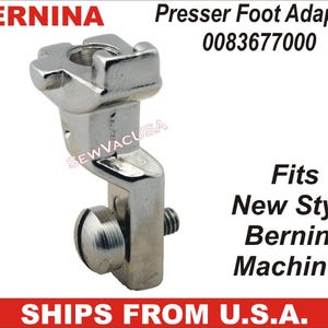 May include: A silver-colored Bernina presser foot adapter for new style Bernina machines. The adapter has a screw and a unique top design. The text "Presser Foot Adaptor" and "Fits New Style Bernina Machines" are visible.