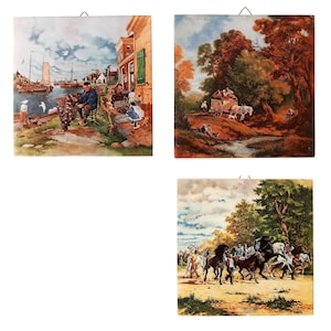 May include: A set of three square wall art pieces with vintage landscape scenes. One shows a harbour scene with figures, boats, and buildings. Another depicts a horse-drawn carriage in a forest. The third shows people with horses.