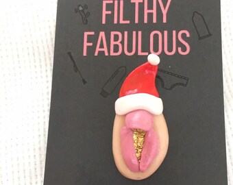 Christmas vulva Santa hat badge. Handmade rude Secret Santa gift idea, funny stocking filler. Made with polymer clay and gold leaf