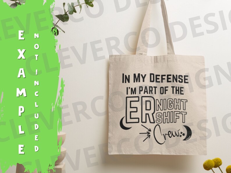 May include: A white canvas tote bag with black text that reads "In my defence I'm part of the ER Night Shift Crew." The text is styled with a crescent moon and a star on either side of the text.