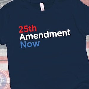 May include: Navy blue t-shirt with the text "25th Amendment Now" in red, white, and blue. The shirt features a classic crew neck and short sleeves. The shirt color is navy.