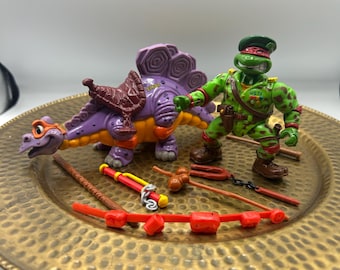 Tortugas Ninja Mutantes Adolescentes Vintage de los años 90: El Estegosaurio Tonto de Mike el Cavernícola y Ralph el Boina Verde.