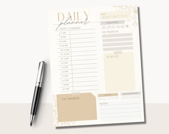 May include: A printable daily planner with a beige background and floral accents. The planner includes sections for today's schedule, top priorities, to do list, mood, water intake, and notes.