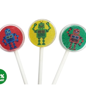 May include: Three round lollipops with robot designs. The lollipops are red, yellow, and green. Each lollipop has a white stick. The text "0% SUGAR" is printed in green on a white background.