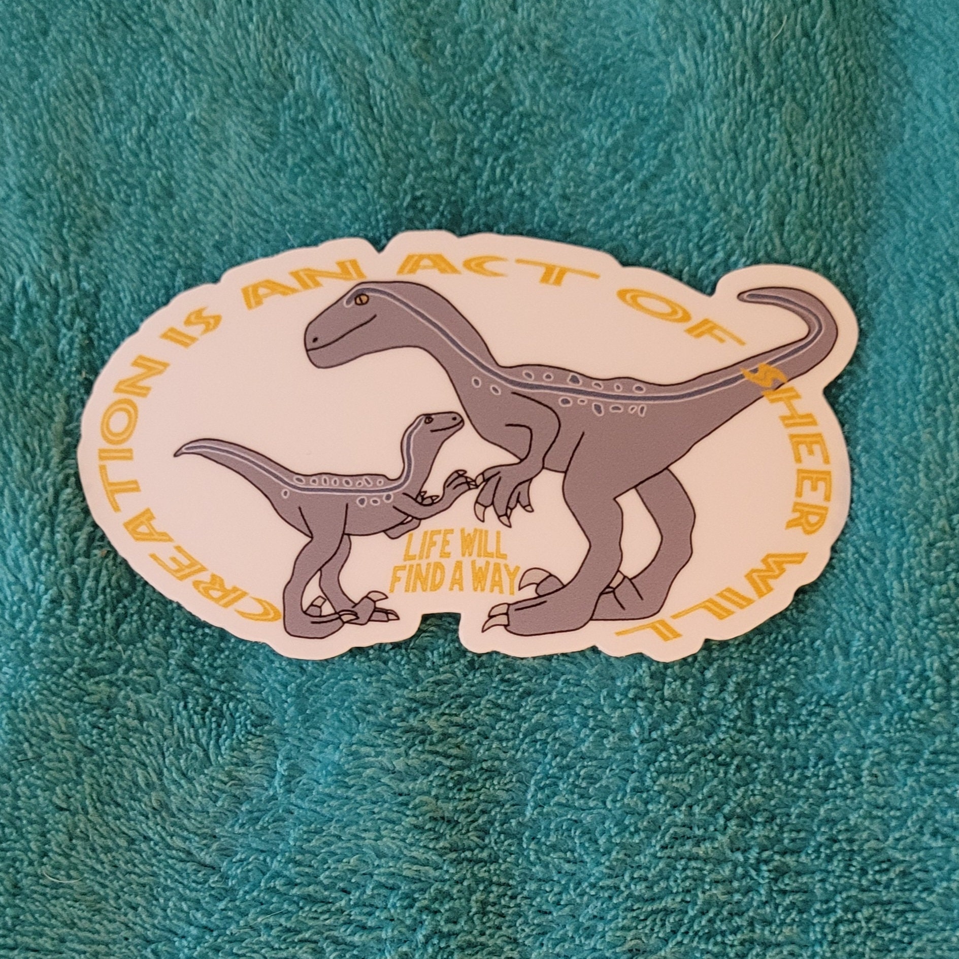 Jurassic World Dominion Sticker Blue and Baby Beta Velociraptor Dinosaur  Says Creation is an Act of Sheer Will and Life Will Find a Way 