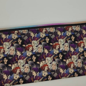 May include: A black zippered pouch with a colorful iridescent zipper pull. The pouch is covered in a repeating pattern of illustrated characters with various hairstyles and clothing.