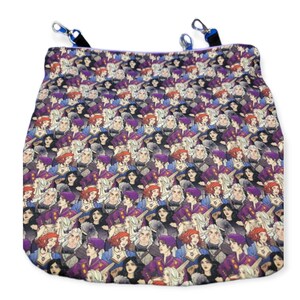 May include: A purple and black fabric pouch with a repeating pattern of cartoon characters. The pouch has two blue clips on the top.