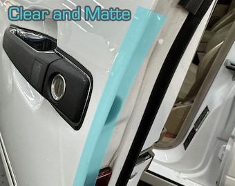 May include: A close-up of a white car door with a black rubber seal. The door is open and the seal is highlighted in blue. The text "Highlighted for Visual Purposes Available in Gloss Clear and Matte" is visible in the top left corner of the image.