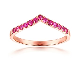 May include: A rose gold ring with a V-shaped band of pink gemstones.