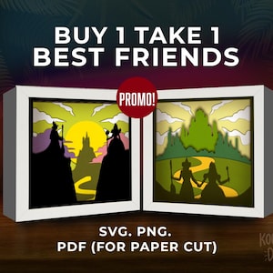 May include: Two framed paper cut art pieces with a fantasy theme. One features silhouettes of figures with a castle and sun, the other a yellow brick road and figures. Text reads "BUY 1 TAKE 1 BEST FRIENDS" and "PROMO!"