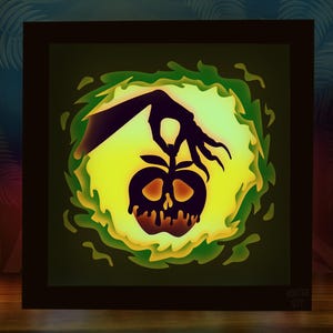 May include: A layered paper art piece featuring a black silhouette of a skeletal apple being held by a shadowy hand. The apple is set against a yellow and green background, with a dark frame. The text "HOOTSIE DIY" is in the bottom right corner.