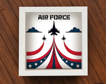 May include: A white frame with a red, white and blue American flag design and the words "AIR FORCE" in black. Three black silhouettes of fighter jets fly in formation.