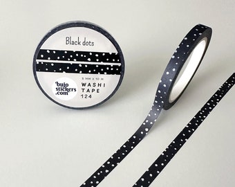 May include: Black washi tape with white dots. The tape is 5 mm wide and 10 meters long. The tape is rolled up on a black spool with the text "bujo stickers.com" and "WASHI TAPE 124" printed on it.