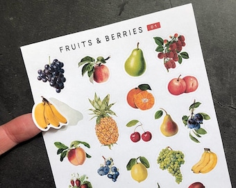 May include: A sheet of stickers featuring various fruits and berries, including bananas, pineapples, pears, cherries, grapes, strawberries, and mangoes. The stickers are printed on white paper with a red and white title "FRUITS & BERRIES 01".