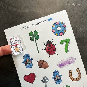 Adesivi portafortuna: gatto portafortuna, ghianda, ferro di cavallo, quadrifoglio, arcobaleno, coccinella, 7, mano di Hamsa, cristallo, cuore, chiave, ciambella