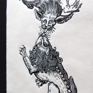 May include: Black and white woodcut print of a lion and a winged creature. The lion is on the bottom and the winged creature is on top. The winged creature is biting the lion's neck.