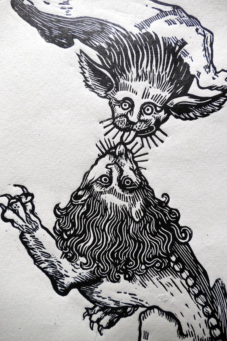 May include: Black and white woodcut print of a winged creature with a long tongue licking the head of a lion.