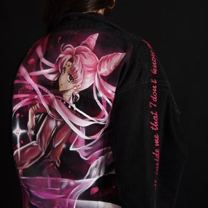 May include: Black denim jacket with a pink and white anime character painted on the back. The text "and inside me that I don't know" is written in pink on the right sleeve. The jacket has a silver button and the text "Ms Juliette" is written in silver on the bottom.