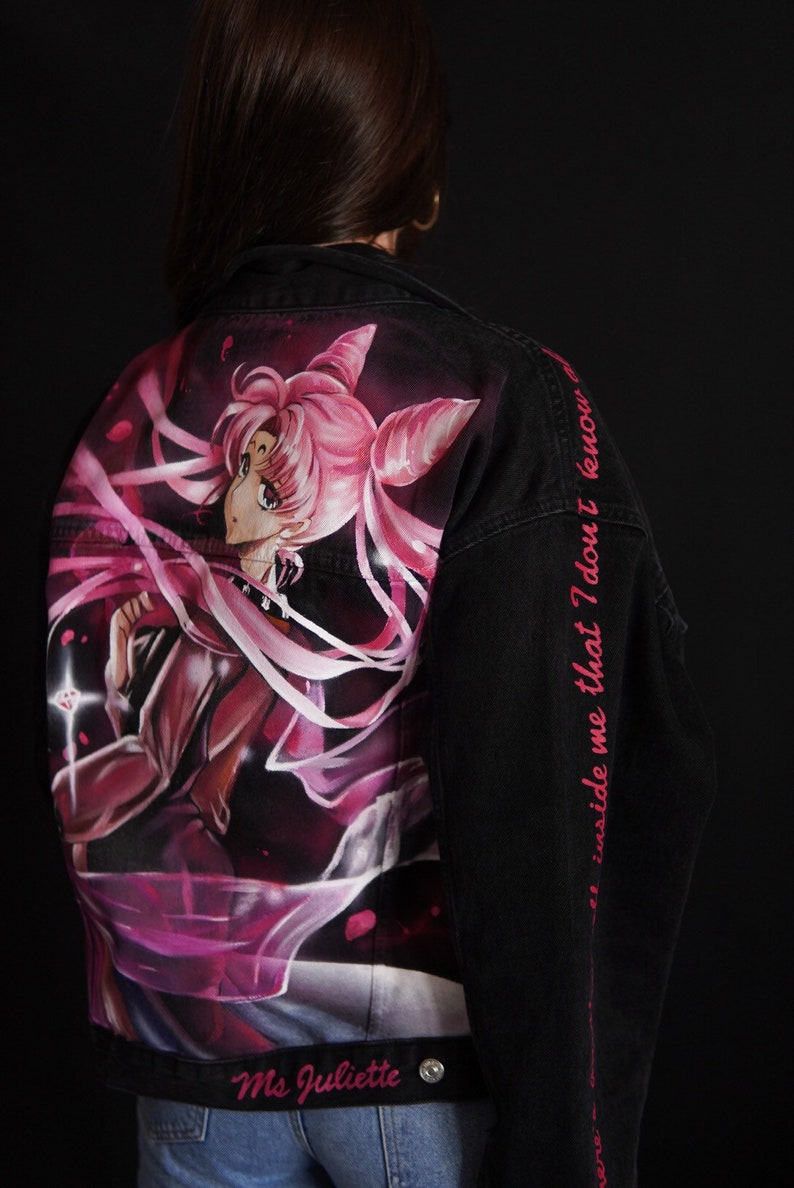 May include: Black denim jacket with a pink and white anime character painted on the back. The text "and inside me that I don't know" is written in pink on the right sleeve. The jacket has a silver button and the text "Ms Juliette" is written in silver on the bottom.