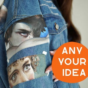 May include: A light blue denim jacket with painted artwork on the sleeves. The artwork features detailed portraits of eyes and faces. An orange circle with the text "ANY YOUR IDEA" is visible.