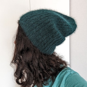 May include: A dark green fuzzy beanie hat.