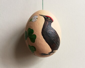 Hand-painted Easter egg with birds and flowers