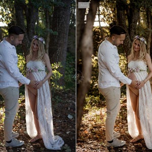 May include: A couple poses outdoors in a forest setting. The woman wears a white strapless gown with floral accents and a flower crown. The man wears a white button-down shirt and khaki pants. The image is a maternity photoshoot.