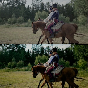 May include: Two riders on horseback, dressed in historical military uniforms, ride across a grassy field. The horses are brown, and the riders wear blue and red jackets with black hats. The scene is set against a backdrop of trees.