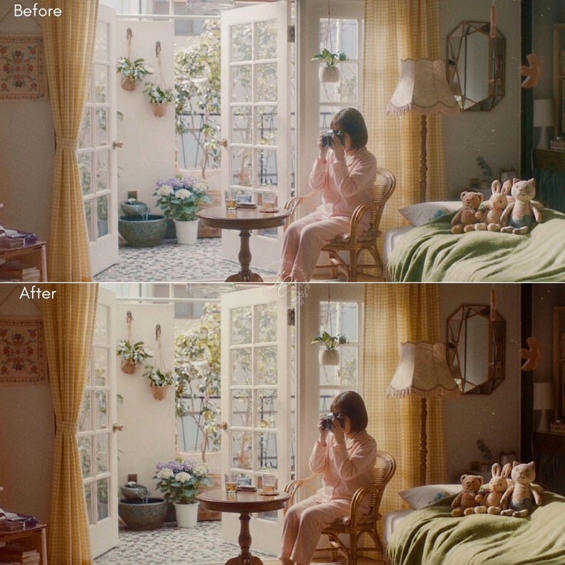 May include: A person in pink pajamas sits in a wicker chair, holding a camera. The scene is bathed in soft light, with a bed covered in a green blanket and stuffed animals. A small round table and open doors lead to a patio.