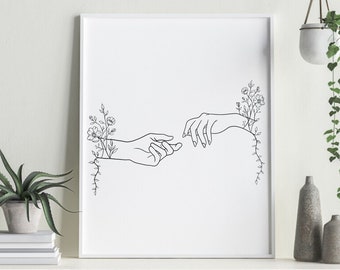 May include: A black and white line art print of two hands reaching towards each other, with flowers growing from their wrists.