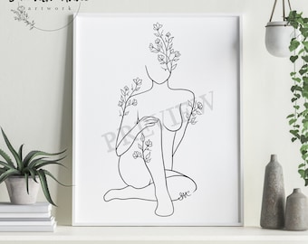 May include: A framed black and white line art print. The artwork depicts a seated figure with floral elements. The text "Samantha Anne artwork" is in a circle at the top left. The figure's face is partially obscured by flowers.