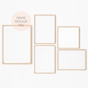 May include: Four wooden picture frames with white mats on a white wall. The frames are arranged in a staggered pattern. The frames are all the same size and shape.