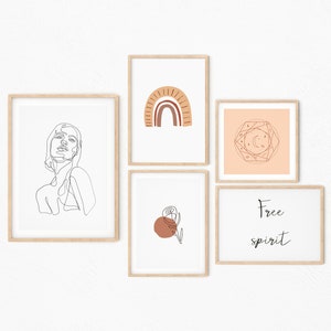 May include: Five framed prints with minimalist line art designs. The prints feature a woman's face, a rainbow arch, a geometric design with stars and moons, a single flower with a red circle, and the text "Free spirit".