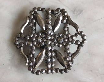 Antique cut steel belt buckle.