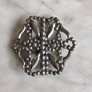 Antique cut steel belt buckle.