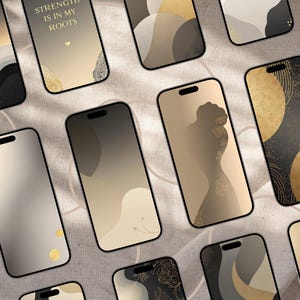 May include: A collection of smartphones with various abstract wallpaper designs in shades of gold, black, and beige. Some phones feature text that reads "STRENGTH IS IN MY ROOTS". The phones are arranged on a neutral-toned fabric surface.