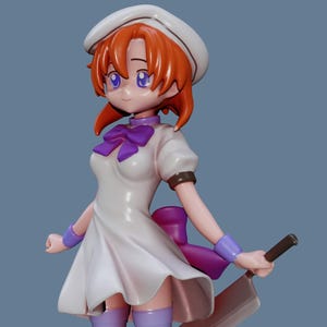 May include: A figurine of a female character with orange hair, purple eyes, and a white uniform. She wears a white hat, a purple bow, and holds a cleaver. The figure has purple accents on her arms and legs.