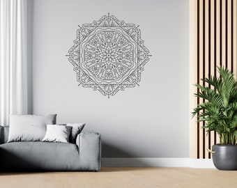 May include: A geometric wall art piece in a symmetrical design, featuring a complex pattern of lines and shapes. The artwork is in a dark gray color and is mounted on a light gray wall. The room also includes a gray sofa, white curtains, and a potted plant.