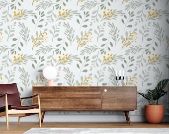 May include: A living room interior with a wooden dresser and a brown leather armchair. The wall is covered in a white wallpaper with a repeating pattern of gray and yellow leaves.