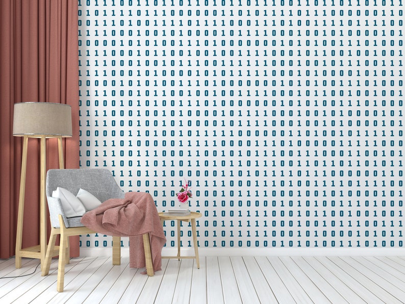 May include: A living room interior with a red curtain, a wooden floor, a grey armchair with a pink throw blanket, a wooden side table with a vase of pink flowers, and a floor lamp with a beige lampshade. The wall is covered with a white wallpaper with a repeating pattern of blue 1s and 0s.