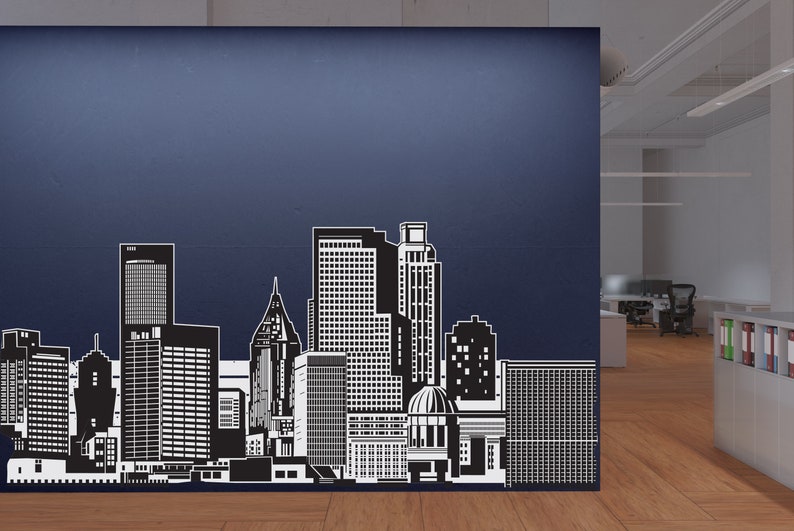 May include: Black and white silhouette of a city skyline with tall buildings, including a dome-shaped building in the centre. The skyline is on a blue wall.