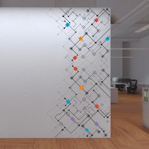 May include: A white wall with a geometric pattern in black, gray, and various colors. The pattern features connected lines, circles, and squares. The wall is in an office setting with a wooden floor and a bookshelf in the background.