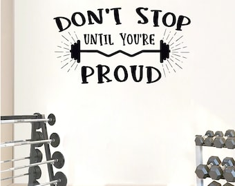 May include: Black and white motivational quote wall decal with the text "Don't Stop Until You're Proud" and a barbell with weights on each end.
