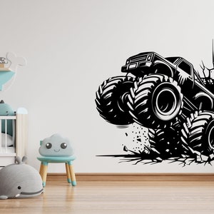 May include: Black and white silhouette of a monster truck breaking through a cracked wall. The truck has large tires and is in mid-air.