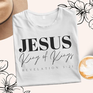 May include: White t-shirt with black text that reads "JESUS King of Kings REVELATION 3:21".