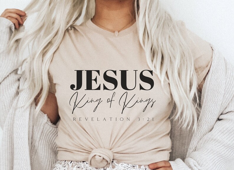 May include: A beige t-shirt with the text "JESUS King of Kings REVELATION 3:21" printed in black.
