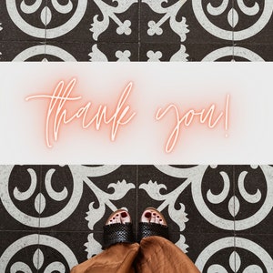 May include: A person wearing black sandals with a brown skirt standing on a black and white tiled floor. The text "thank you!" is written in pink neon letters on a white background.