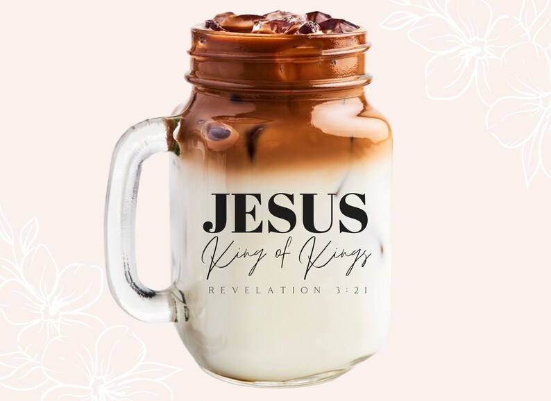 May include: A mason jar filled with iced coffee and ice cubes. The jar has a handle and the text "JESUS King of Kings REVELATION 3:21" is printed on the side.