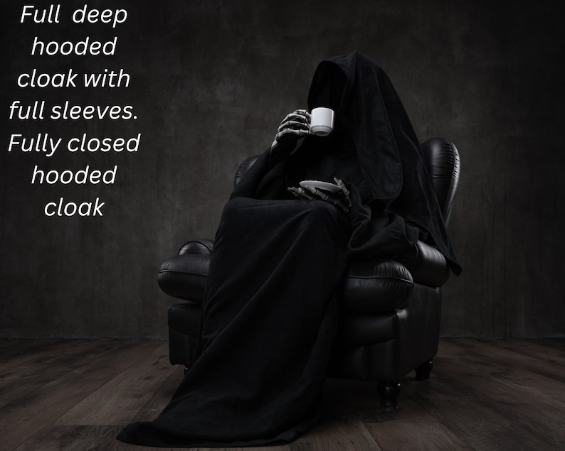 May include: A full deep hooded cloak with full sleeves and a fully closed hood. The garment is black and worn by a skeletal figure holding a white cup and saucer. The text on the image reads: Full deep hooded cloak with full sleeves. Fully closed hooded cloak.